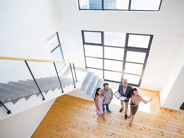 people discussing home features in a modern space two real estate agents and two clients